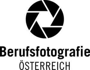 Dies ist das Logo für Berufsfotografie Österreich, einem professionellen Fotografieverband in Österreich. Das Logo ist schwarz-weiß und besteht aus einem Kamera-Symbol und dem Text “Berufsfotografie Österreich”. Das Kamera-Symbol ist ein Kreis mit einer diagonalen Linie durch ihn hindurch. Der Text ist in einer serifenlosen Schriftart geschrieben und in Großbuchstaben geschrieben.